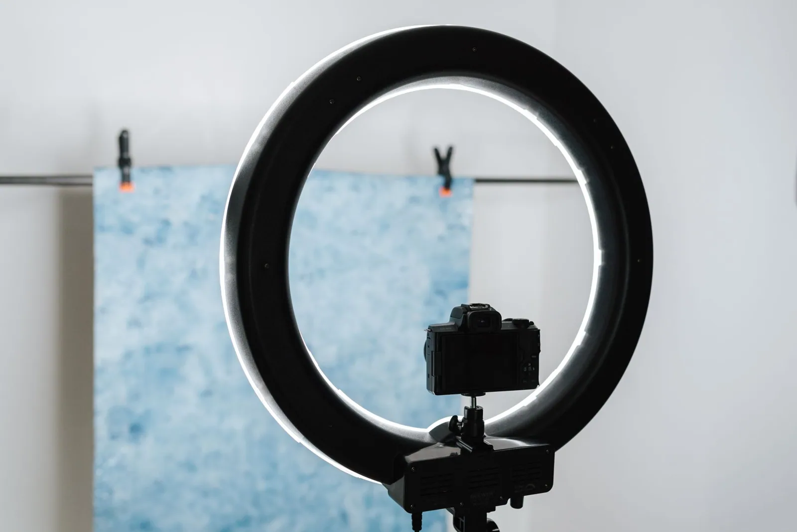Camera and ring light set up in a studio