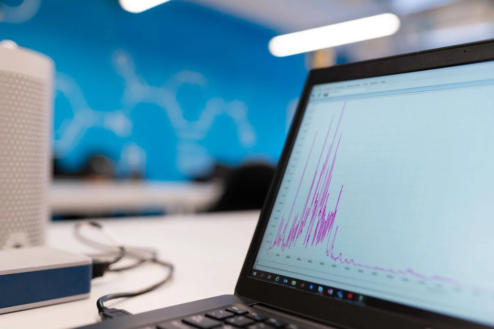 Laptop showing a growth graph on an office desk