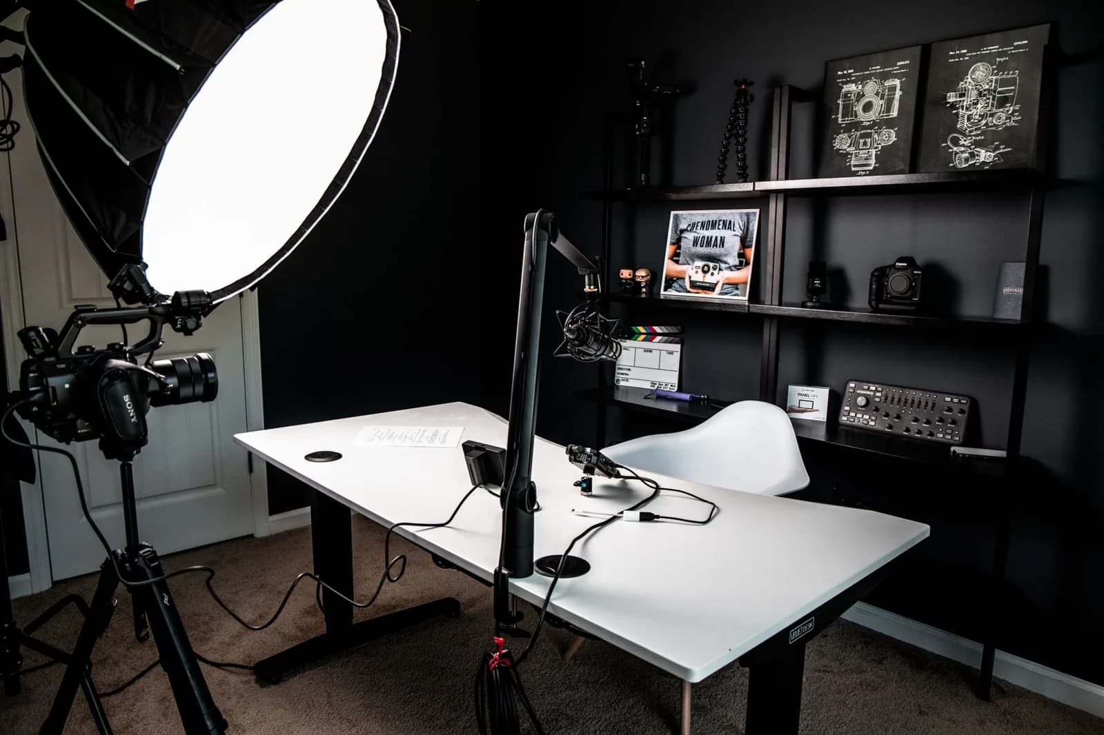 Small studio with a ring light, camera and white desk