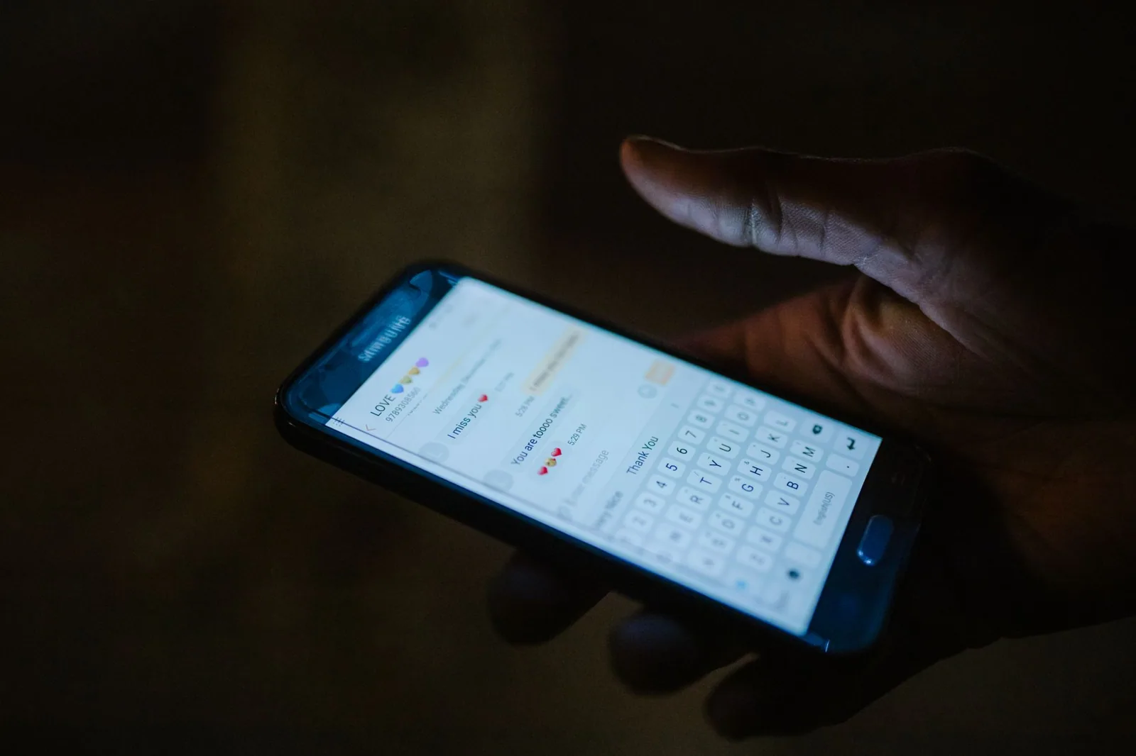 Smartphone with a messaging app open in a dark room