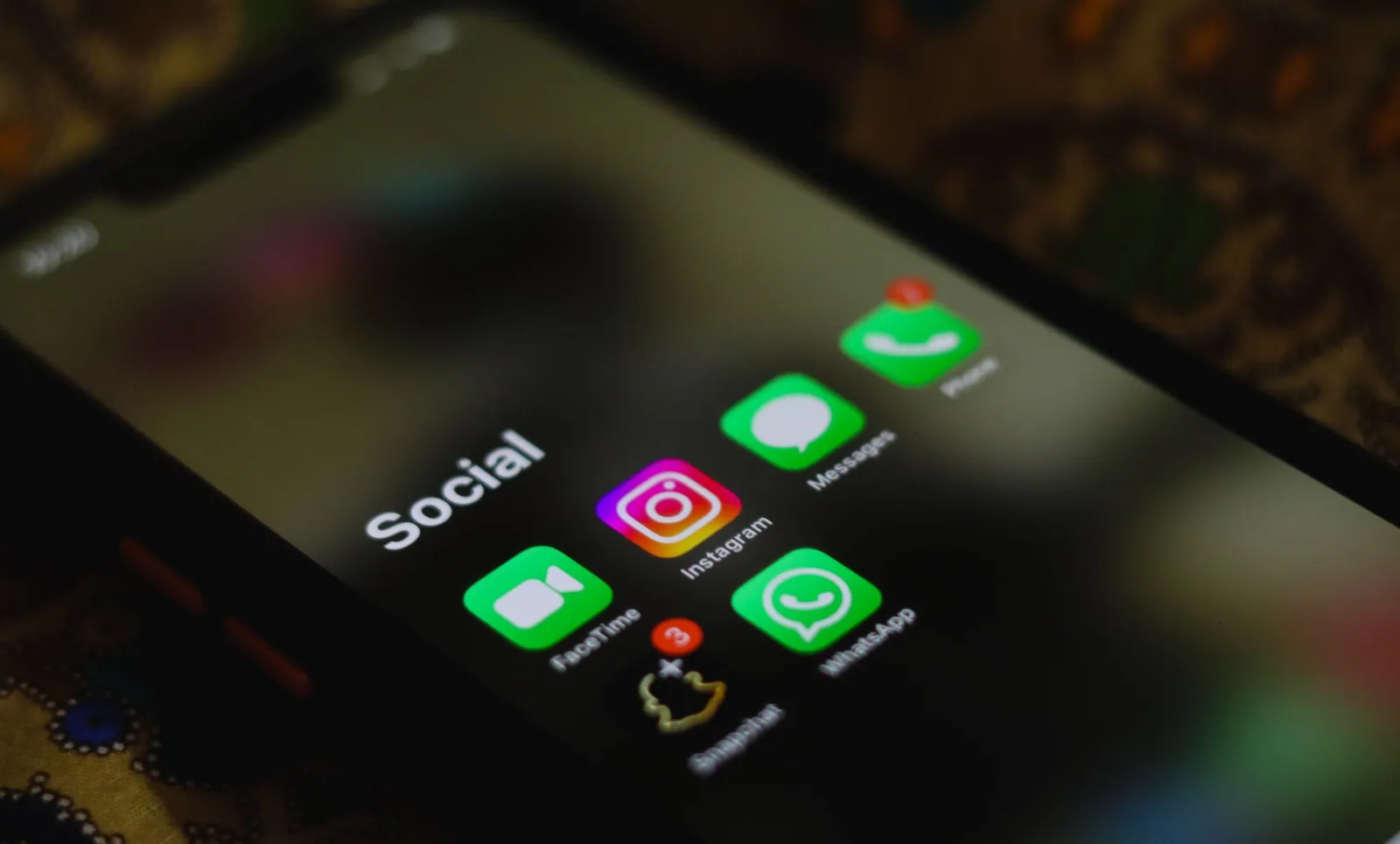 Phone screen with a folder of social media apps