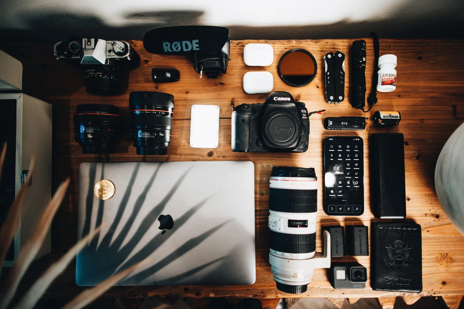 Cameras, lenses and recording gear laid out on a table