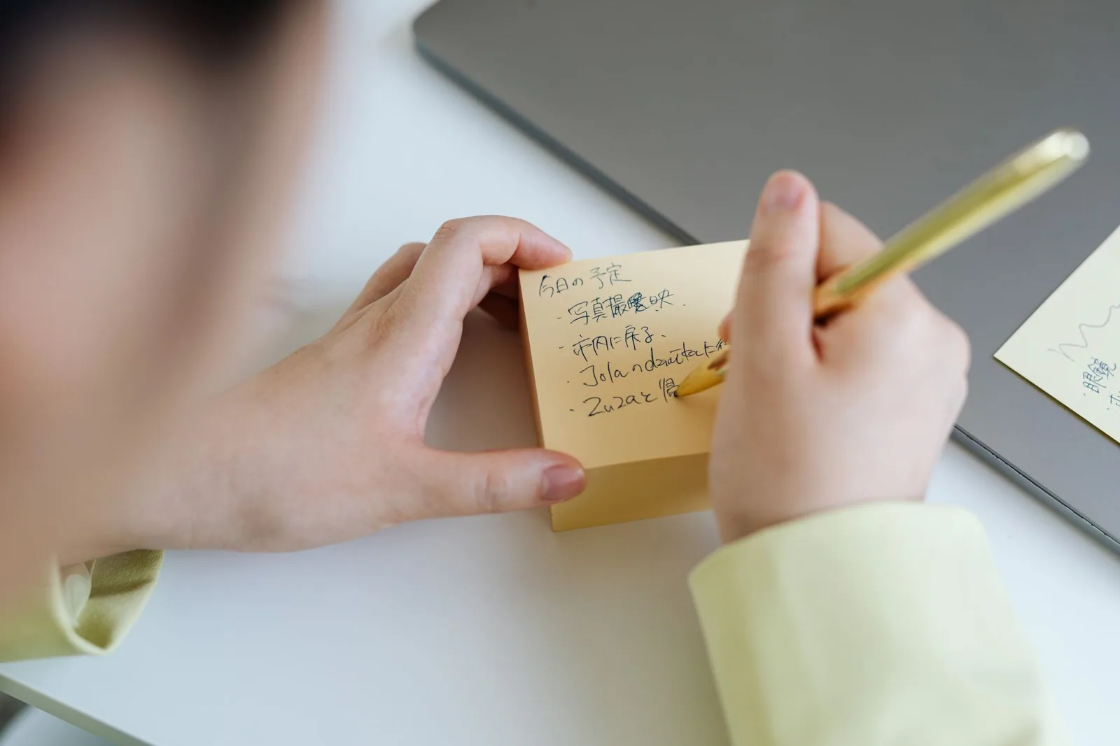 Handwritten note on a yellow sticky pad