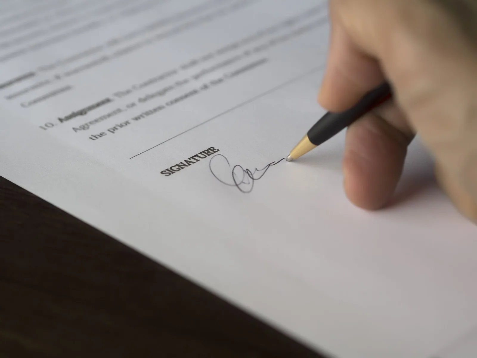 Pen signing a printed agreement
